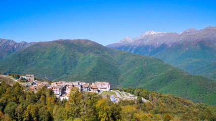 Small town in the mountains. Town in the mountains. City against the backdrop of mountains and forests.