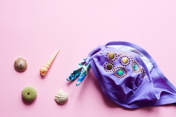 Swimsuit on pink background - pop art concept design, minimalism, flat lay