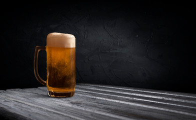 mug of beer on dark background drink
