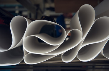 A beautiful smooth clean paper roll machine creating a continuous sheet of white freshly made paper...