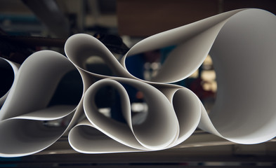 A beautiful smooth clean paper roll machine creating a continuous sheet of white freshly made paper...