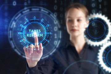 The concept of business, technology, the Internet and the network. A young entrepreneur working on a virtual screen of the future and sees the inscription: taxes reform