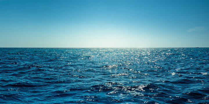 Blue ocean panorama with sun reflection, The vast open sea with clear sky, Ripple wave and calm sea with beautiful sunlight