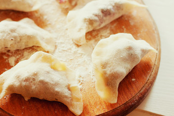 Sweet dumplings with blackberry - process of making. Top view, closeup