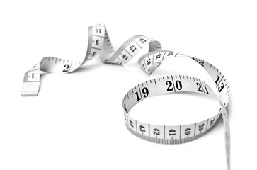 Curly measure tape, dieting or weight loss theme, isolated on white background. Black and white...