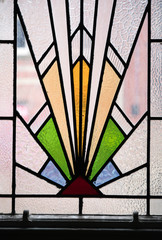 A beautiful bright art deco stained glass decorative window panel in an an abandoned hotel. Art...