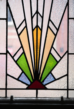 A Beautiful Bright Art Deco Stained Glass Decorative Window Panel In An An Abandoned Hotel. Art Deco Design Between 1908 To 1935. Triangular Shapes.