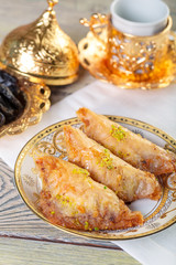 Turkish traditional Dessert Baklava with tea on dark background. Fresh and healthy dessert.