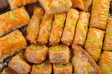 Turkish sweets baklava and metal oriental tray on wooden background