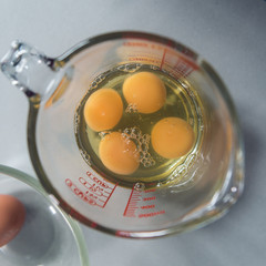 Free range organic egg yolks in a glass measuring jug, shot from above with beautiful shallow depth...