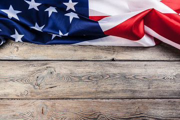 USA flag on light wooden table background close up copy space