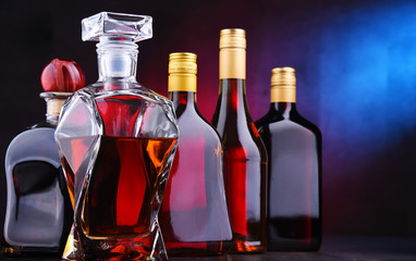 Carafe and bottles of assorted alcoholic beverages