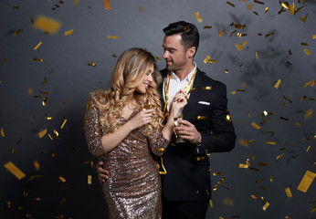 Couple embracing and drinking alcohol at studio shot