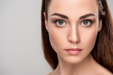 Fototapeta premium portrait of attractive young woman with perfect skin, isolated on grey