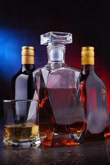 Carafe and bottles of assorted alcoholic beverages