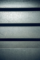 A hard  solid silver and grey industrial machinery metal texture background, showing signs of...