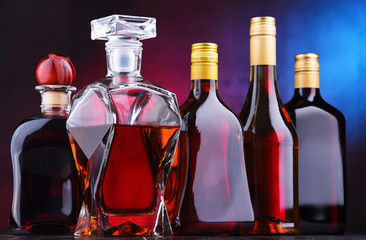 Carafe and bottles of assorted alcoholic beverages