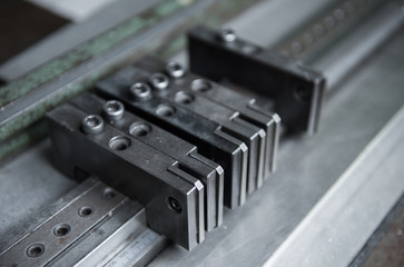 Vintage lead letterpress printing blocks against a weathered metal drawer background with bokeh.