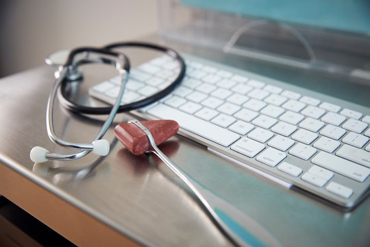 Close up of reflex hammer,  stethoscope, and keyboard