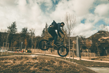Fototapeta premium BMX rider making tricks .Guy riding a bmx bike