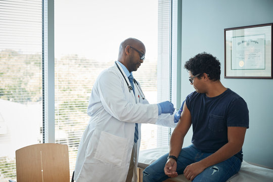 Doctor giving an injection to a patient