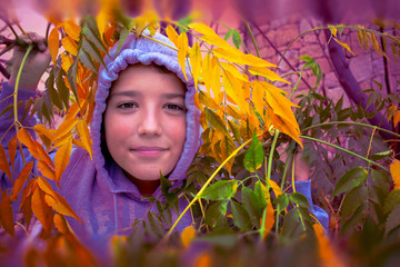 handsome guy in the hood surrounded by colorful autumn leaves