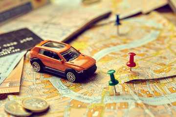 Fototapeta na wymiar travel concept - small toy car on the map
