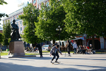 NIZHNY NOVGOROD, RUSSIA - JULY 28, 2018: Young people skateboarding on the side of Bolshaya Pokrovskaya street located in the city center