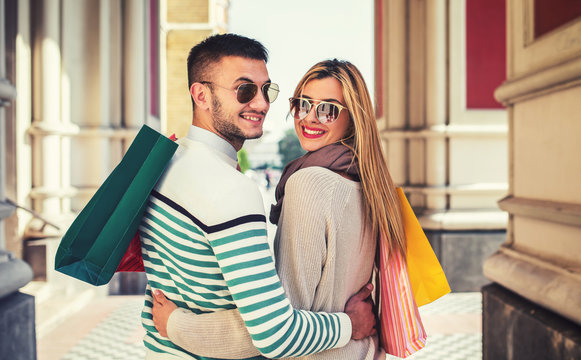 Happy couple in shopping. Consumerism, love, dating, lifestyle concept