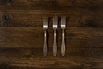 Set of vintage forks on a wooden background