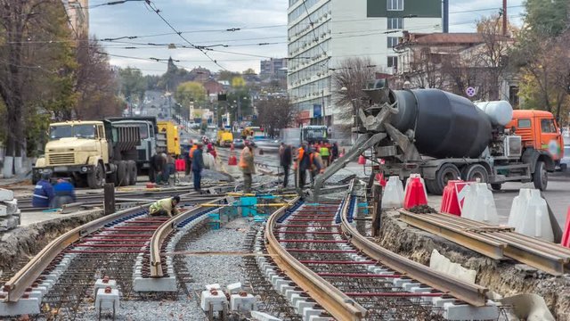 Pouring ready-mixed concrete after placing steel reinforcement to make the road by concrete mixer timelapse.