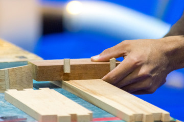 Carpenter working with timber in shop