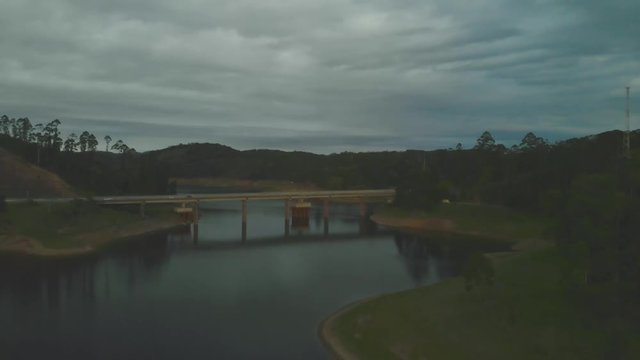 wide drone shot of bridge of tamoios road over paraibuna reservoir