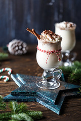 Eggnog with cinnamon for Christmas and winter holidays. Traditional Christmas drink eggnog. Christmas dessert