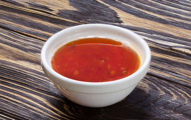 Red sauce on wooden background