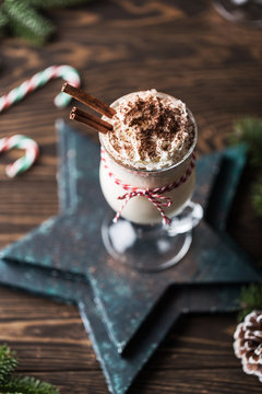 Eggnog with cinnamon for Christmas and winter holidays. Traditional Christmas drink eggnog. Christmas dessert