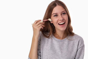 Teen Skin Care and natural look make up : Young woman , teenage girl covering face with powder foundation