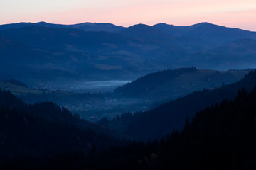 Fantastic view on the mountain forest in autumn - sunset in the Carpathians