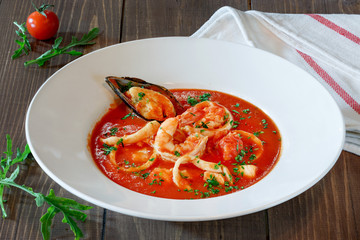 Red soup with mussels, shrimps and seafood