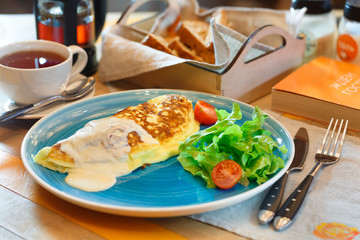 Egg omelet with vegetables on a plate on the table
