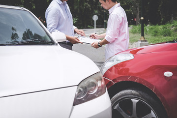 Insurance Agent examine Damaged Car and customer filing signature on Report Claim Form process...
