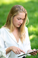 Fototapeta na wymiar Young woman using tablet computer or smartphone