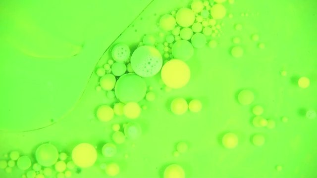 Yellow and green balls on light neon green background