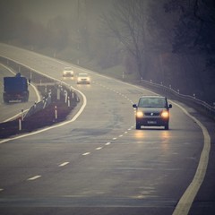 Fototapeta na wymiar Bad weather driving - foggy hazy country road. Motorway - road traffic. Winter time.