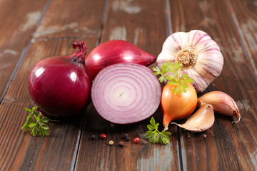 fresh red onion, garlic on wood background