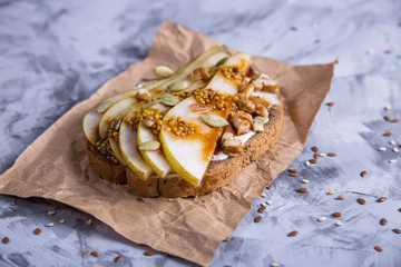 Beautiful healthy snack - sandwich with cream cheese, pear slices, mustard and sesame seeds and...