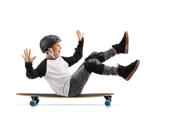 Happy boy with helmet sitting on a longboard and riding