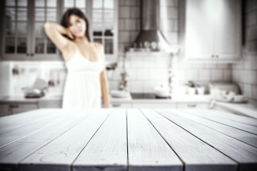 slim young woman and white wooden table in kitchen 