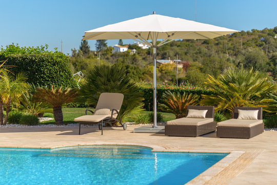 Sun bath with sun loungers and parasol. In Portugal.