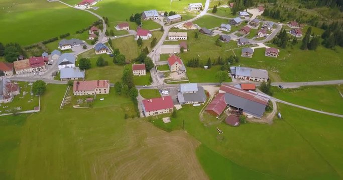 Aerial, tilt up, drone shot, of a small town in the french countryside, on a sunny day, in Chapelle des bois, Doubs and Jura regional park, Franche comt&radic;&copy;, in France